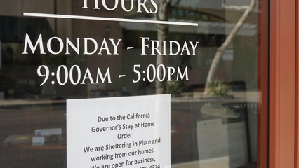 Sign on storefront advises of closure due to Coronavirus social distancing and shelter in place regulations.