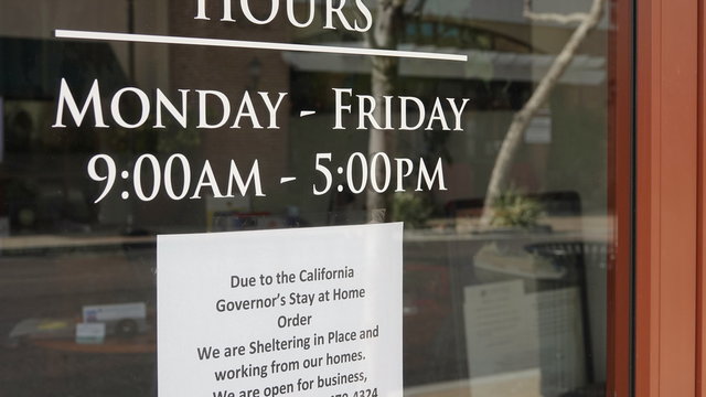 Sign On Storefront Advises Of Closure Due To Coronavirus Social Distancing And Shelter In Place Regulations.