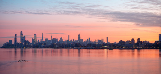 Fototapeta na wymiar Panoramic view of Midtown Manhattan at sunrise from Harborside Place, Jersey City, New Jersey