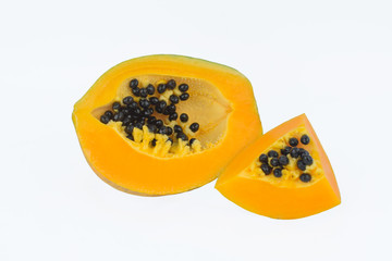 One and a half sliced pieces of fresh yellow ripe papaya fruit isolated before a white background