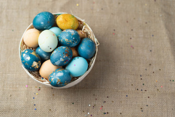 Basket with Easter eggs, festive colored eggs