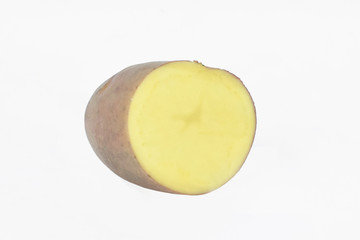 Side view of a big brown potato sliced in half before a white background