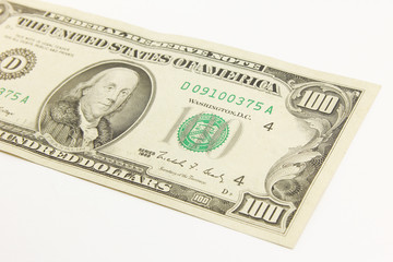 One hundred dollar cash banknotes on white background