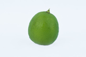Side view of a fresh green colored medium sized lemon isolated in a white background
