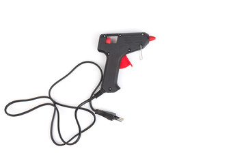 Naklejka premium Electric hot glue gun on white background. Rods for glue gun