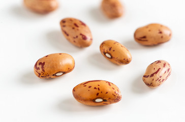 Fototapeta na wymiar Pinto beans on white background closeup