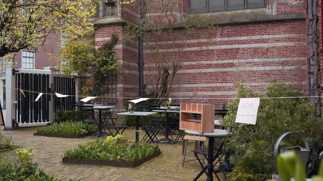 Closed European cafe due to coronavirus covid19, empty tables and inscriptions on leaflets - coffee take-away