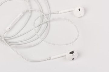 White headphones for listening to music and sound on portable devices: music player, smartphone, laptop and jack for connection on a white background.