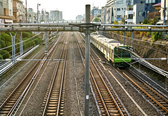Fototapeta premium Train goes through one of many railroad in Tokyo