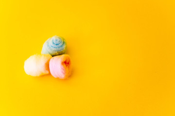 colored cotton wool ball. Yellow background. Free copy space. Hygiene
