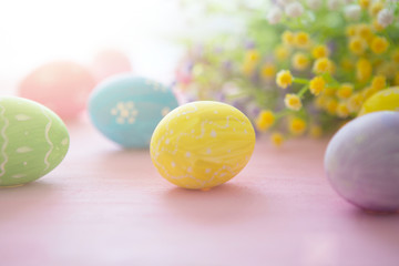 Easter eggs on a pink wooden surface