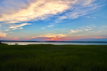 sunset over green field