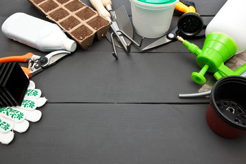 A lot of different garden equipment on the wooden table