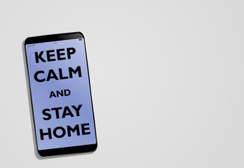 Desk with smartphone with text keep calm and stay home