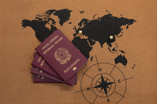 European Union and Italian Republic passports on world map with Wuhan and Rome indicated