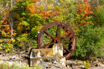 Water wheel in Bracebridge, Ontario Canada. It is possible to see the movement of the wheel, that is blurred in the picture.