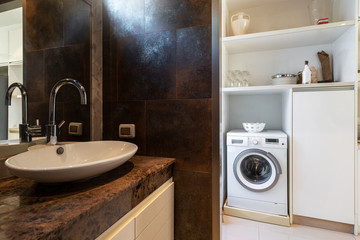 Sink in bathroom and white washing machine in luxurious house, home, villa, condo and apartment