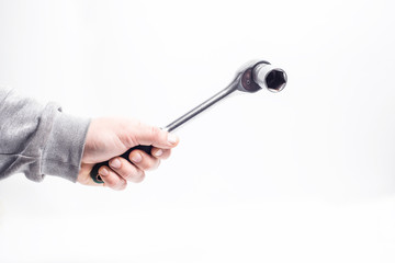 Ratchet key with 24mm head in hand, close - up white background