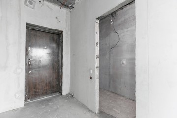 interior of a new apartment without finishing in gray tones with electrical wiring