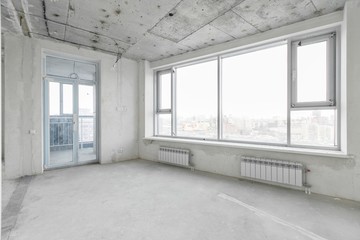interior of a new apartment without finishing in gray tones with electrical wiring