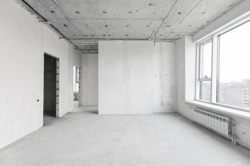 interior of a new apartment without finishing in gray tones with electrical wiring