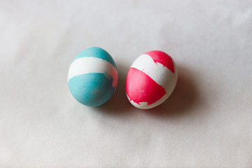 two easter eggs on a white pergament paper diy design natural and messy