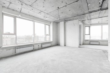 interior of a new apartment without finishing in gray tones with electrical wiring