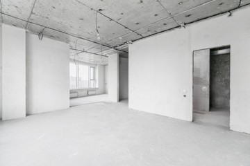 interior of a new apartment without finishing in gray tones with electrical wiring