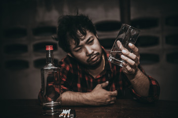 Asian man drink vodka alone at home on night time,Thailand people,Stress man drunk concept