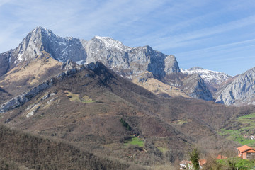 mountain landscape on a clear day from the highest part of an Asturian town, we can also see the roofs of the houses