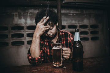 Asian man drink vodka alone at home on night time,Thailand people,Stress man drunk concept