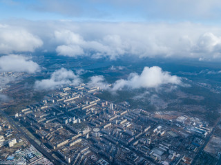 High flight in the clouds over the city of Kiev.