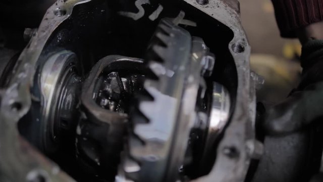 Open gearbox reduction before welding. The metal part of the car. Machine oil