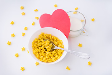 a bowl of cornflakes stars for Breakfast with love. Useful breakfast. Ready breakfast with milk. Bowl of corn stars