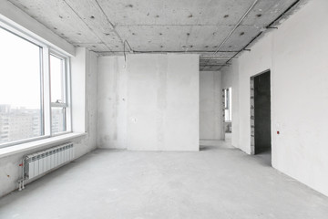 interior of a new apartment without finishing in gray tones with electrical wiring