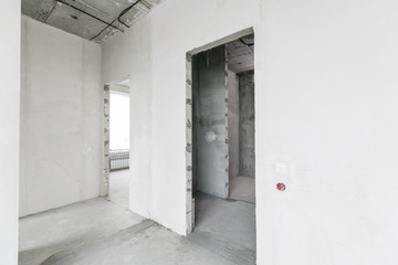 interior of a new apartment without finishing in gray tones with electrical wiring