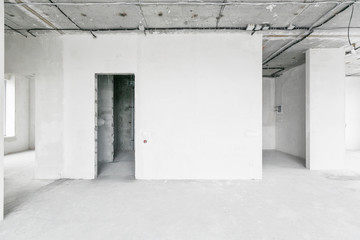 interior of a new apartment without finishing in gray tones with electrical wiring