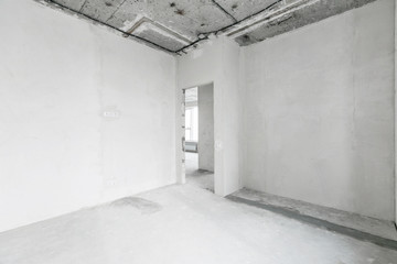 interior of a new apartment without finishing in gray tones with electrical wiring