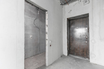 interior of a new apartment without finishing in gray tones with electrical wiring