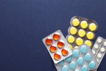 cough pills on blue background