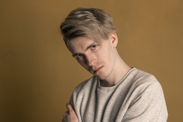 Obraz premium guy with long dyed hair on a yellow background