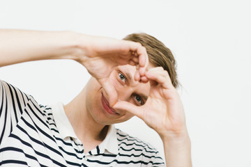 man making a hand heart frame