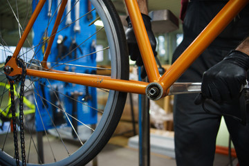 Workshop worker performs maintenance work and restores bicycle.