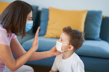 Mother and child putting on protective masks during coronavirus pandemic