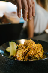 Young chef couple cooking noodle in a kitchen in a modern restaurant