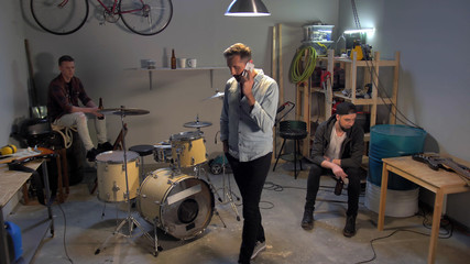 The musician speaks on the phone in the garage