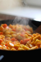 Chopped carrots and butternut squash in a wok. Selective fcous.