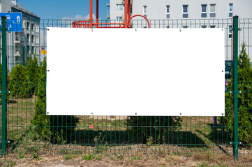 Blank advertising banner mounted on the fence.