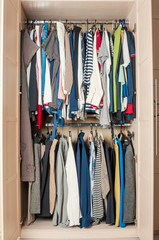 Wardrobe with female clothing in the room