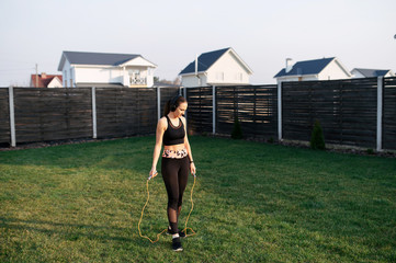 Woman doing cardio workout in the backyard